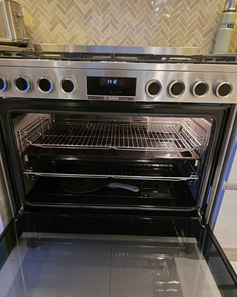 Bosch stainless steel range cooker with the oven door open and shelves fitted