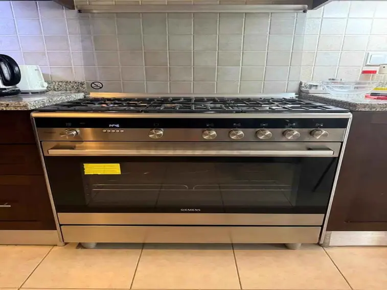 Siemens five burner gas range cooker installed in a villa kitchen