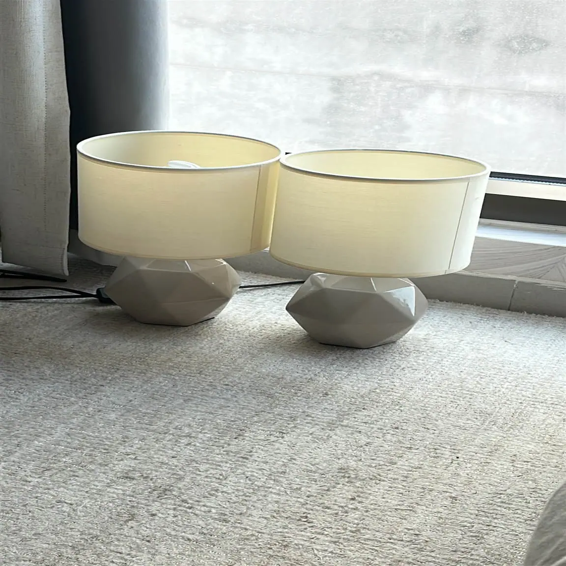 Matching pair of ceramic table lamps with cream fabric shades