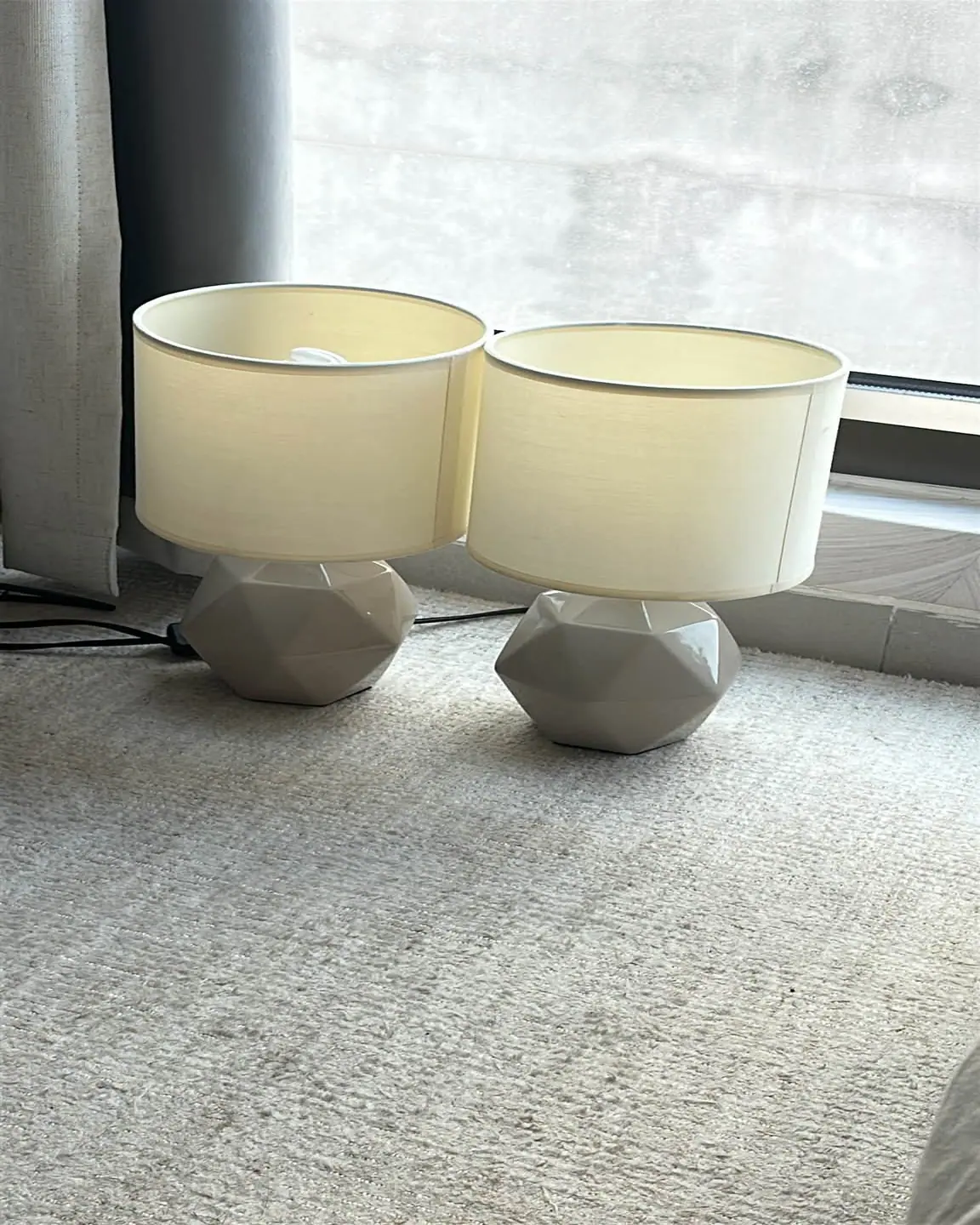 Matching pair of ceramic table lamps with cream fabric shades